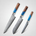 Three Damascus steel knives with wooden handles on a white background