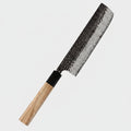 A 67-layer Damascus steel kitchen knife with a hammered blade and an olive wood handle, shown diagonally on a dark blue background with text overlays and red bell pepper props.