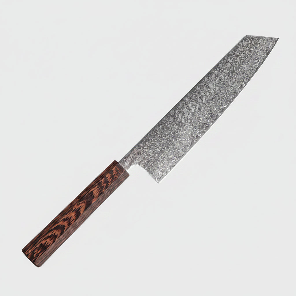 A Japanese-style kitchen knife with a hammered Damascus steel blade and a dark wood handle, placed diagonally on a wooden cutting board next to a raw beef steak garnished with cilantro.
