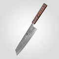 A Dashway 67 Layer Damascus Steel Kiritsuke knife with a patterned steel blade and a dark wood handle, shown standing on a wooden cutting board with raw meat, broccoli, and a tomato against a dark background.
