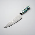 Decorative chef's knife with a patterned blade and colorful handle on a white background