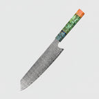 Decorative chef's knife with a wooden handle on a wooden surface with ingredients.